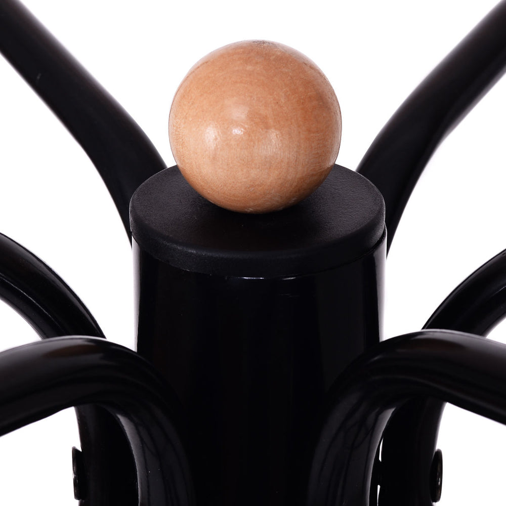 Close-up of the vintage metal coat hat tree stand showing the wooden top ball and sturdy black steel construction.