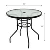 Round 32-inch patio table with tempered glass top and black steel frame, featuring an umbrella hole for outdoor use.