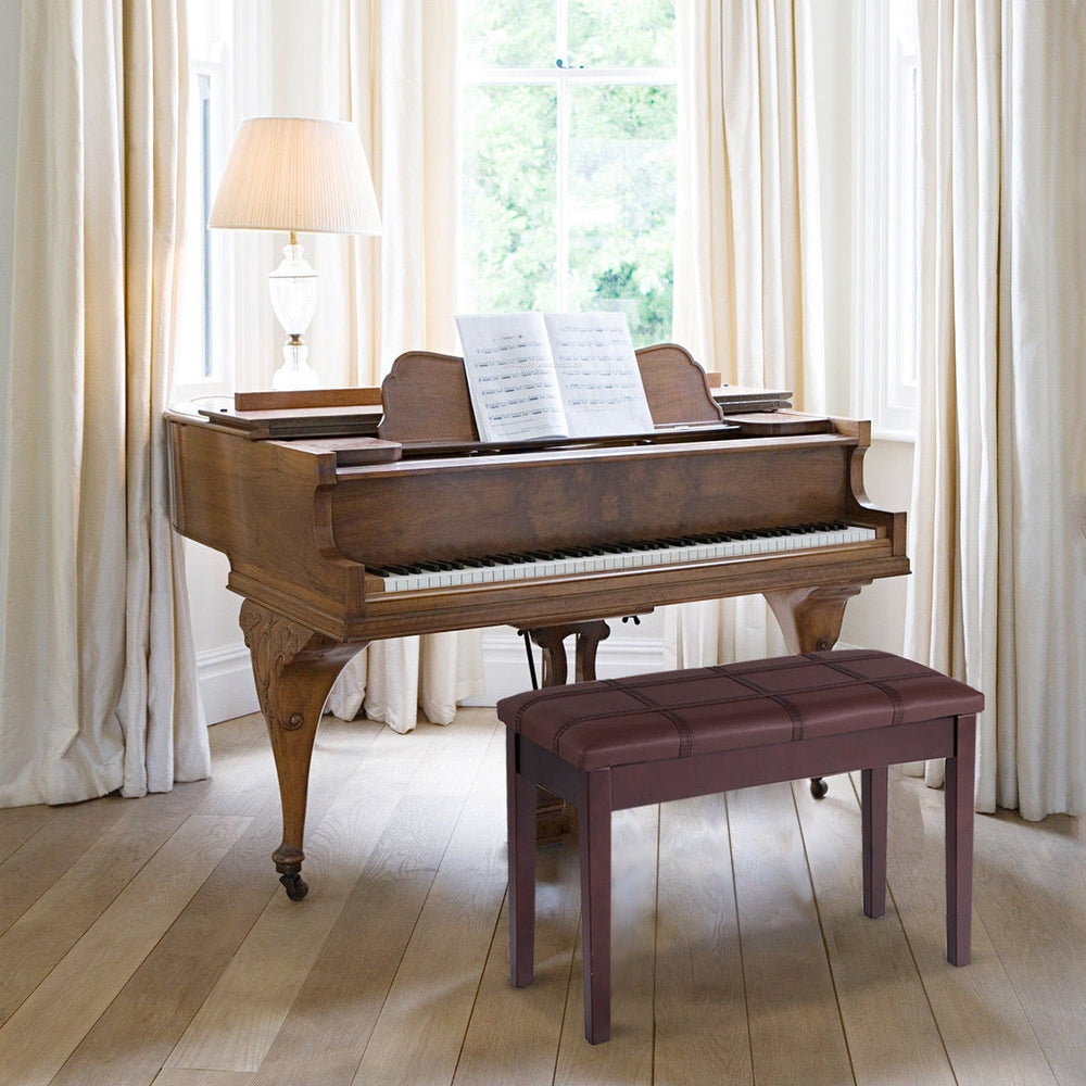 Brown solid wood piano bench with PU leather, padded seat, and storage compartment for sheet music and books.