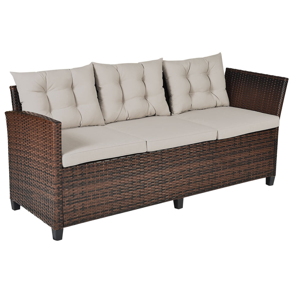 Hand-woven rattan outdoor sofa set with padded cushions, ideal for dining and relaxation in gardens or patios.