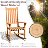 Eucalyptus wood outdoor rocking chair with contoured slatted seat and widened armrests, perfect for patio relaxation.