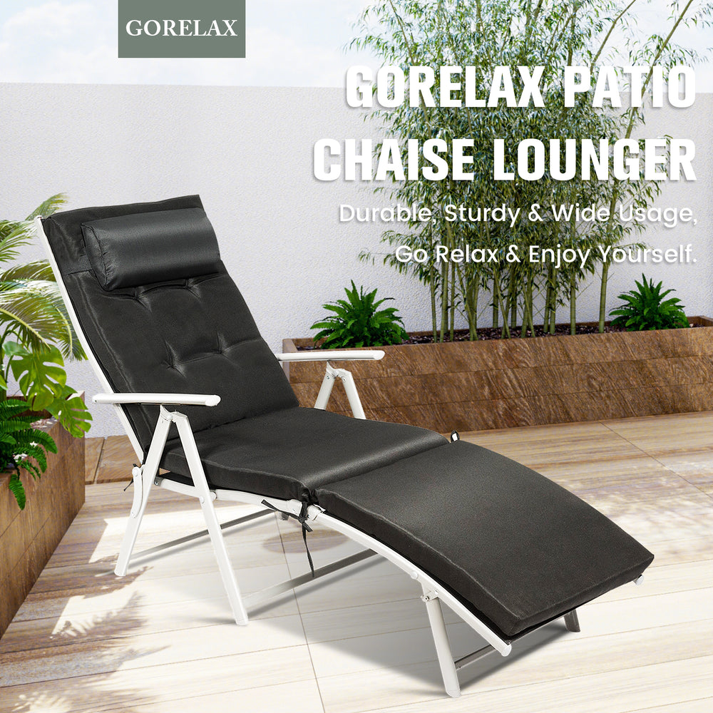 Adjustable black folding chaise lounge chair with removable pillow, perfect for outdoor relaxation by the pool or beach.