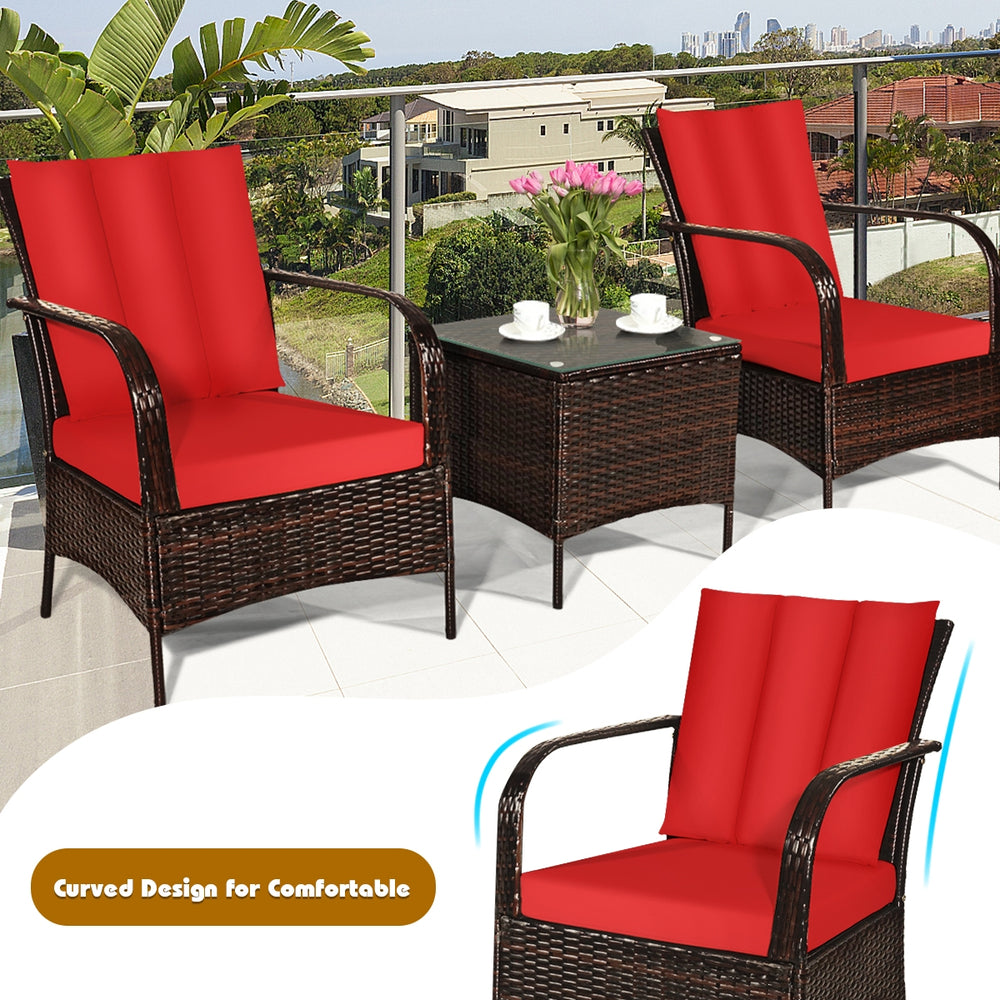 Curved design rattan chair set with red cushions and glass top coffee table, perfect for outdoor patio relaxation.