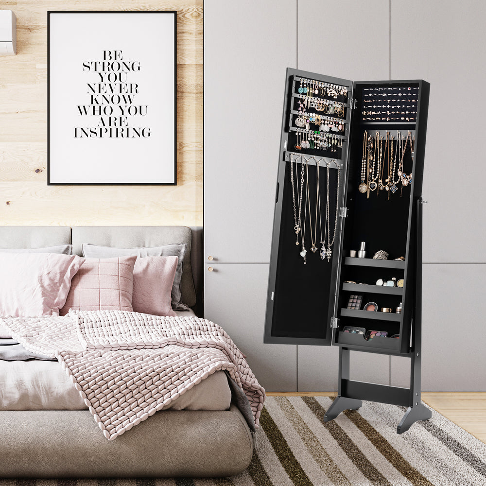 Mirrored standing jewelry cabinet in black with elegant design, featuring ample storage for accessories in a bedroom.