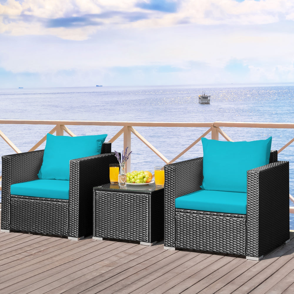 Turquoise cushion patio wicker conversation set with a glass-top table, perfect for outdoor relaxation and gatherings.