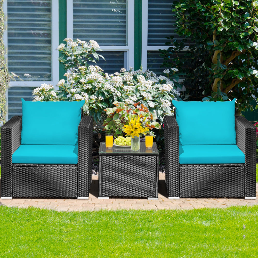 Lush garden scene featuring a 3-piece patio wicker set with turquoise cushions, perfect for outdoor coffee breaks.