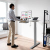 Height adjustable gray hand crank sit to stand desk frame with cable management for a tidy workspace.