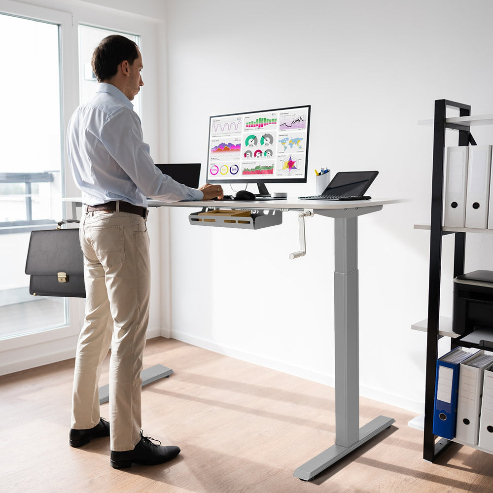 Height adjustable gray hand crank sit to stand desk frame with cable management for a tidy workspace.