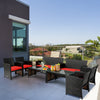 Four-piece patio rattan furniture set with red cushions, including a loveseat and coffee table, ideal for outdoor.