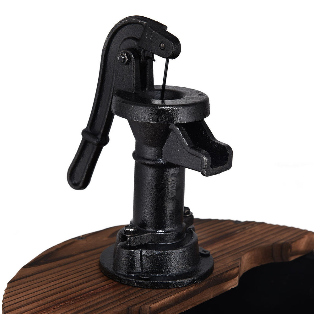 Close-up of the decorative hand pump on the 2-tiers outdoor wooden barrel waterfall fountain for rustic patio decor.