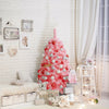 Pink Christmas tree with snow flocked PVC tips, 4.5 ft tall, creating a festive atmosphere for holiday celebrations.