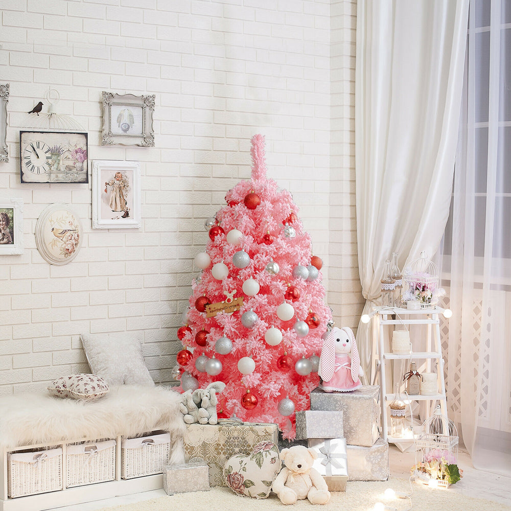 Pink Christmas tree with snow flocked PVC tips, 4.5 ft tall, creating a festive atmosphere for holiday celebrations.
