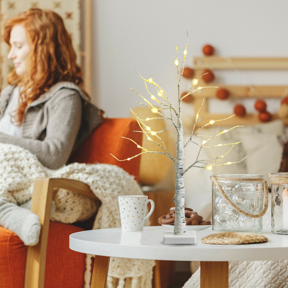 Elegant 2 feet pre-lit white twig birch tree with bendable branches and warm LED lights, ideal for creating a cozy.