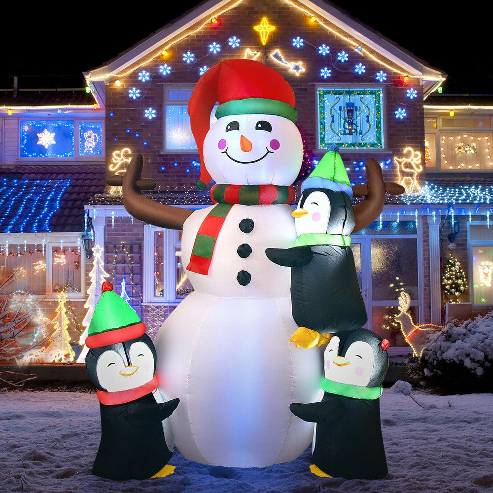 6ft inflatable snowman with penguins, featuring bright lights for festive outdoor decoration in winter settings.
