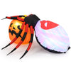 Inflatable spider on a pumpkin with colorful rotating light, perfect for Halloween backyard decoration.