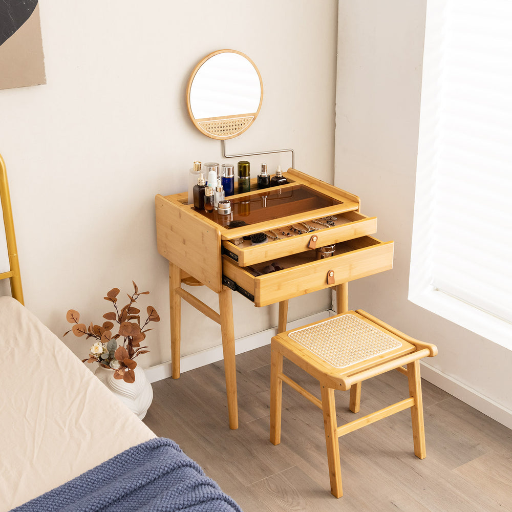 Bamboo vanity stool with rattan top and reinforcement bar, perfect for makeup or as a space-saving footstool.