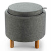 Round gray fabric storage ottoman with removable lid and wooden tray, featuring solid wood legs and non-slip pads.