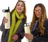 Two women holding a 22 oz beige insulated stainless steel water bottle, ideal for camping and outdoor activities.