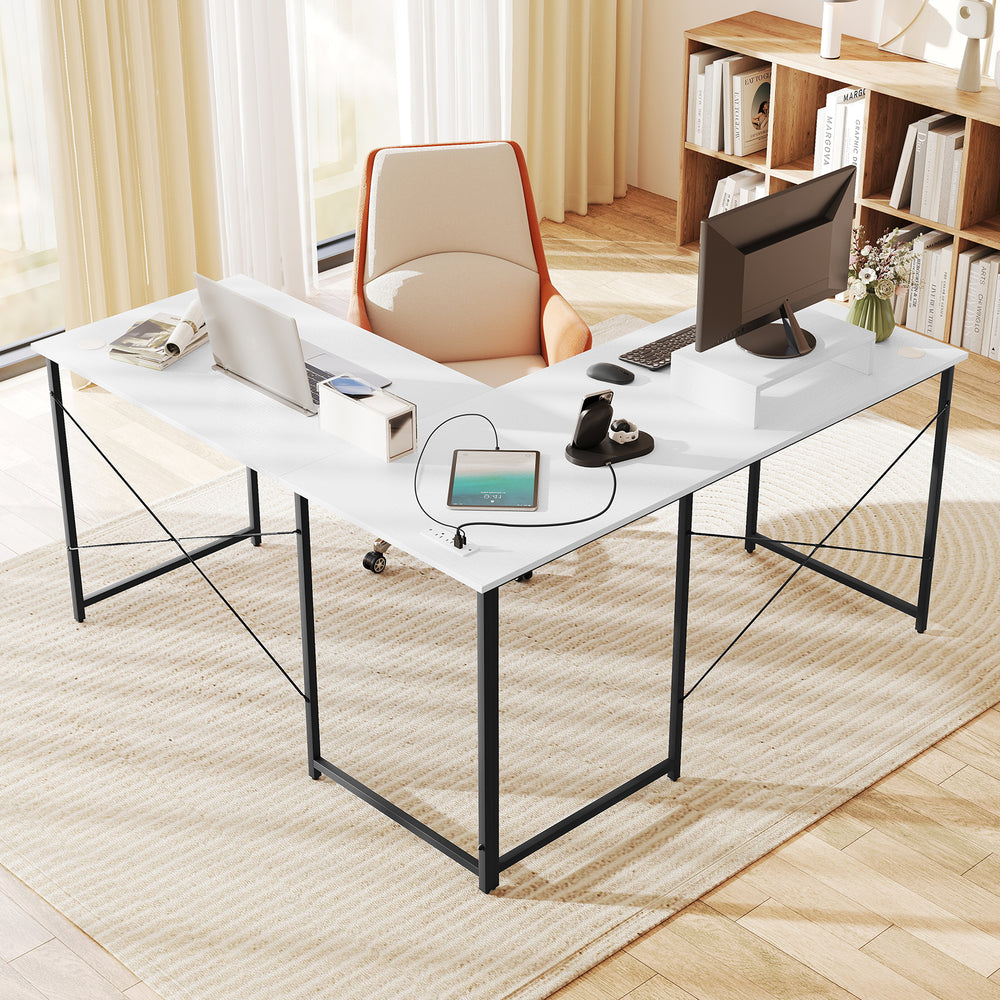 L-shaped computer desk in white showcasing a movable monitor shelf and built-in power strip for convenient device.