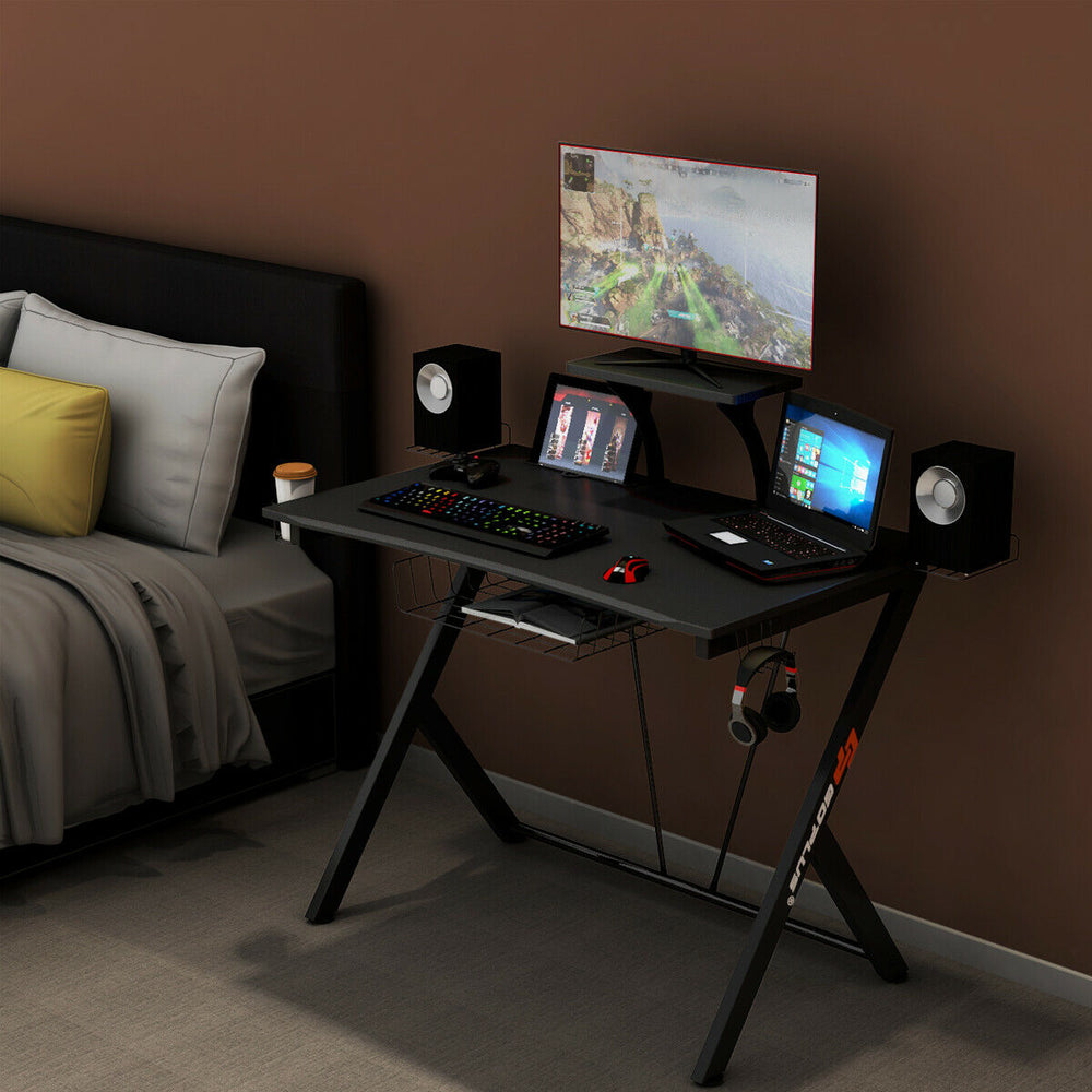 Multifunctional K-shaped gaming desk with monitor shelf, cup holder, and headset hook for organized gaming setup.