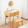 Bamboo makeup vanity table with a glass top, featuring an adjustable mirror and two drawers for organized beauty.