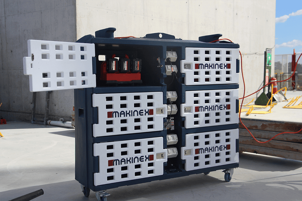 Makinex Mobile Charge Pod (MCP) on a construction site with open locker showing chargers and batteries