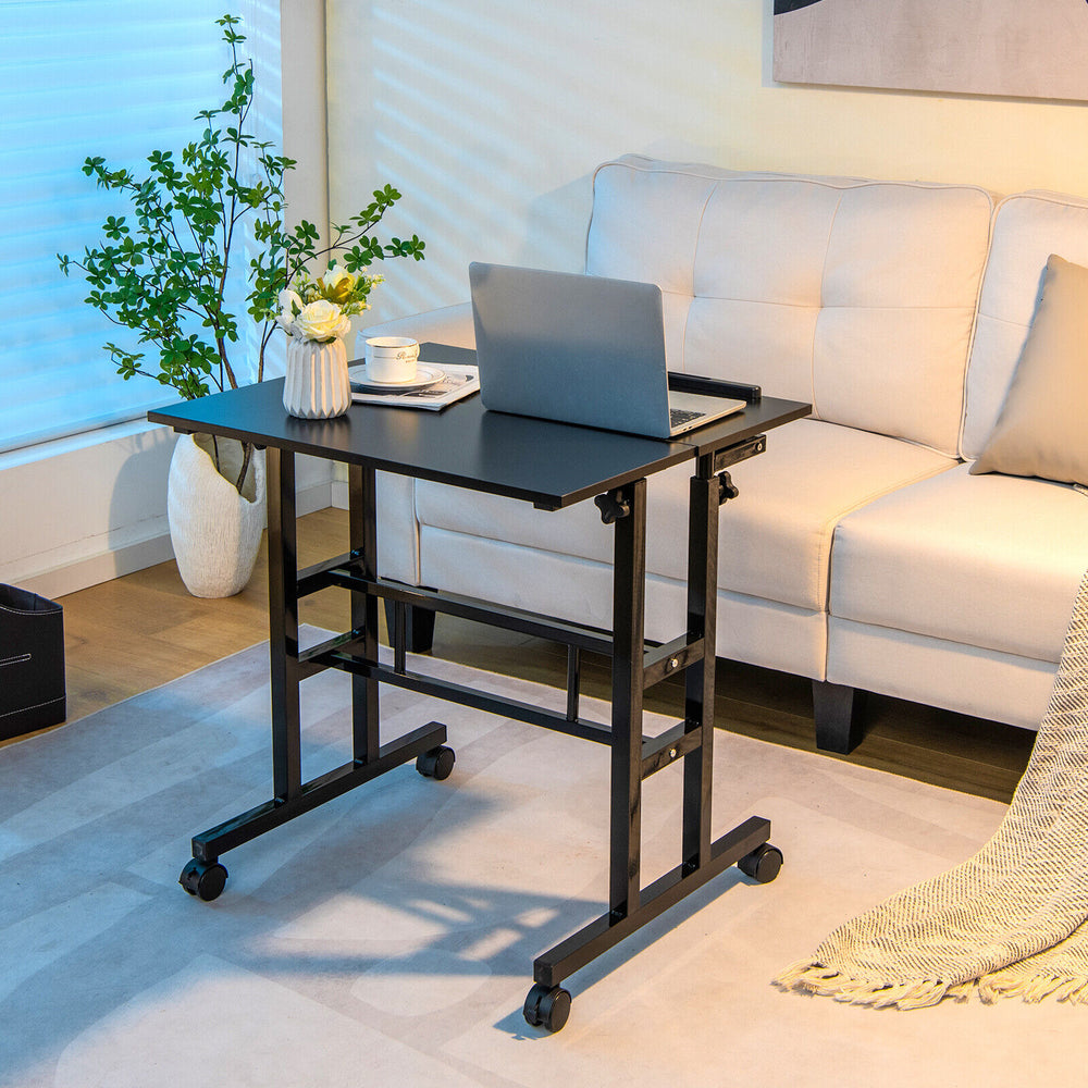 Mobile stand-up computer desk in black with adjustable height and tilting surface, ideal for small spaces and versatile.