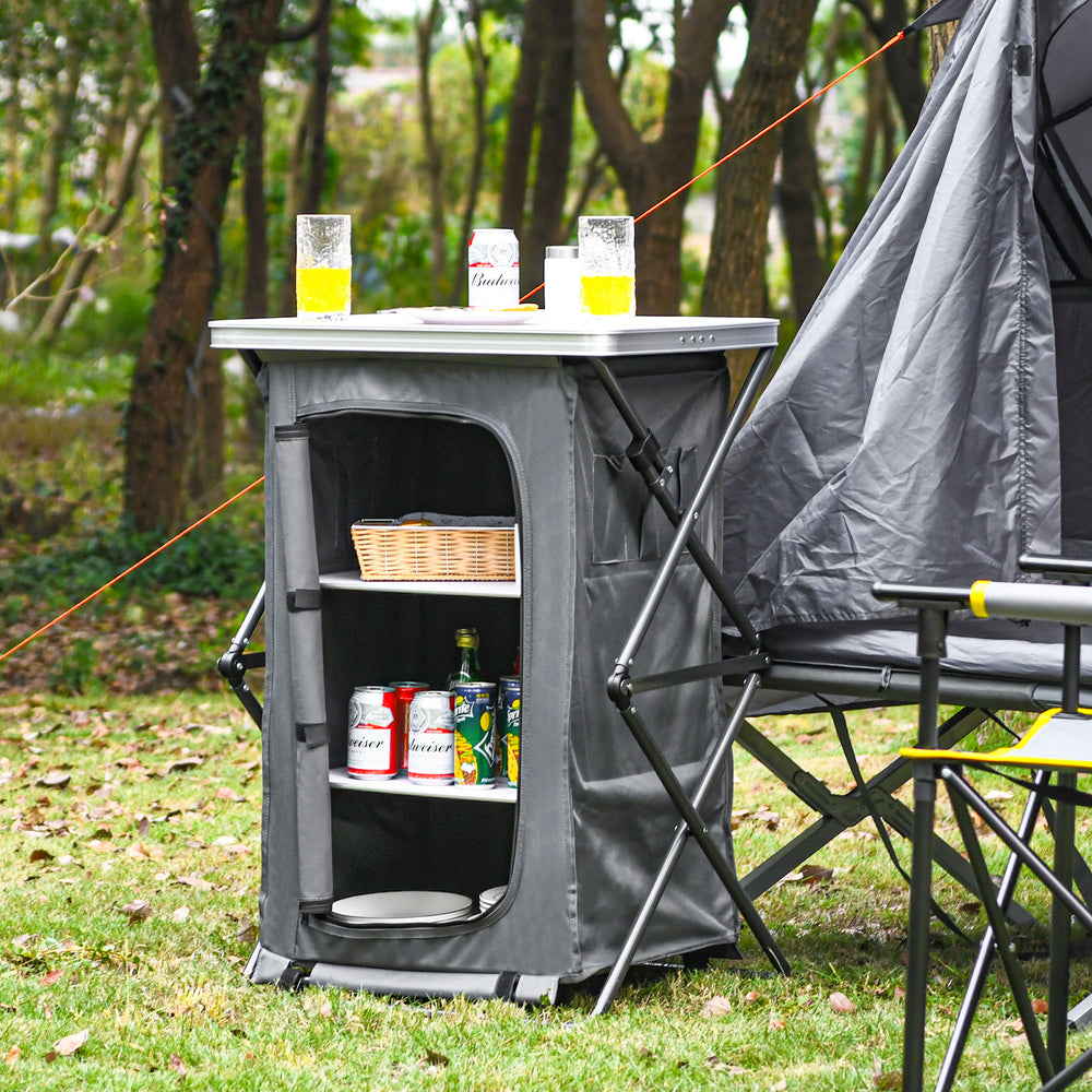 Folding camping storage cabinet with 3 shelves, waterproof oxford cloth, and spacious tabletop for outdoor activities.