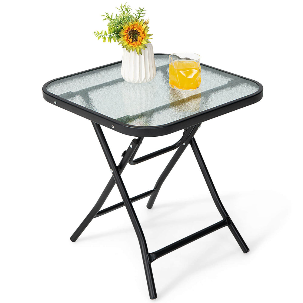 Square 18-inch patio bistro table with rustproof frame and tempered glass top, perfect for outdoor use and easy to fold.
