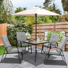 Patio dining set featuring four stackable cushioned chairs and a large umbrella for outdoor comfort and shade.