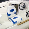 Folding low back fishing boat seat in blue and white with ergonomic support, ideal for marine environments.