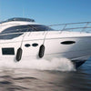 Black 8.5" x 27" ribbed marine boat fender, designed for dock protection and UV resistance, shown on a boat.