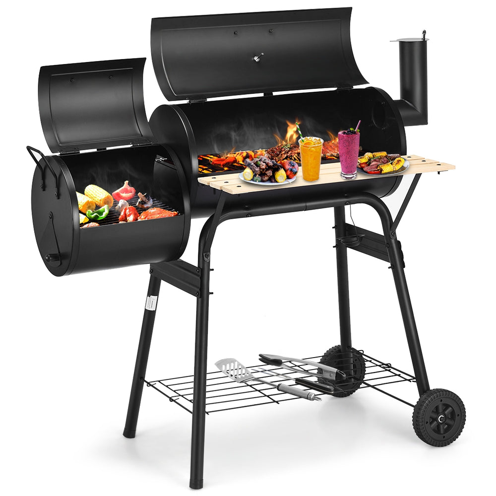 Outdoor BBQ grill with side shelf, durable steel construction, and attached firebox for patio cooking.