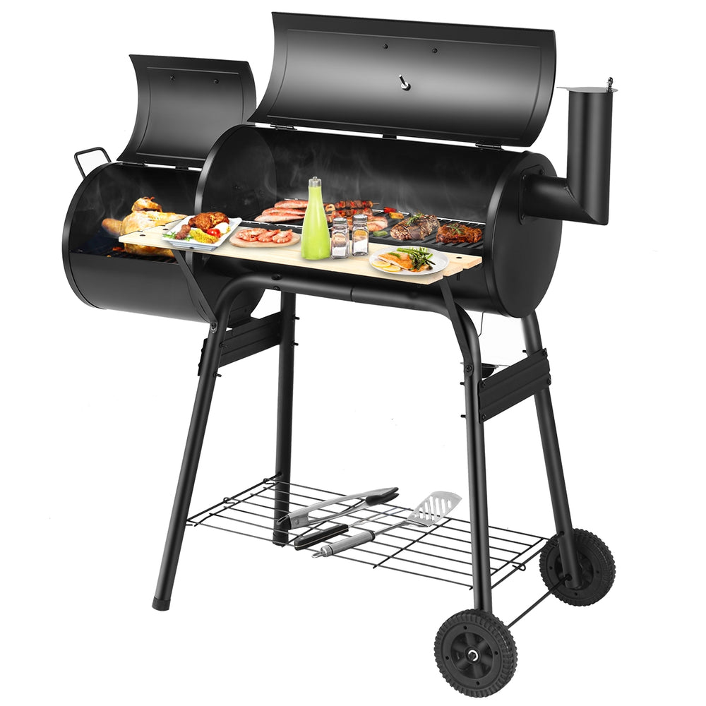 Outdoor BBQ grill with heavy-duty steel construction, side shelf for tools, and attached firebox for offset heat.