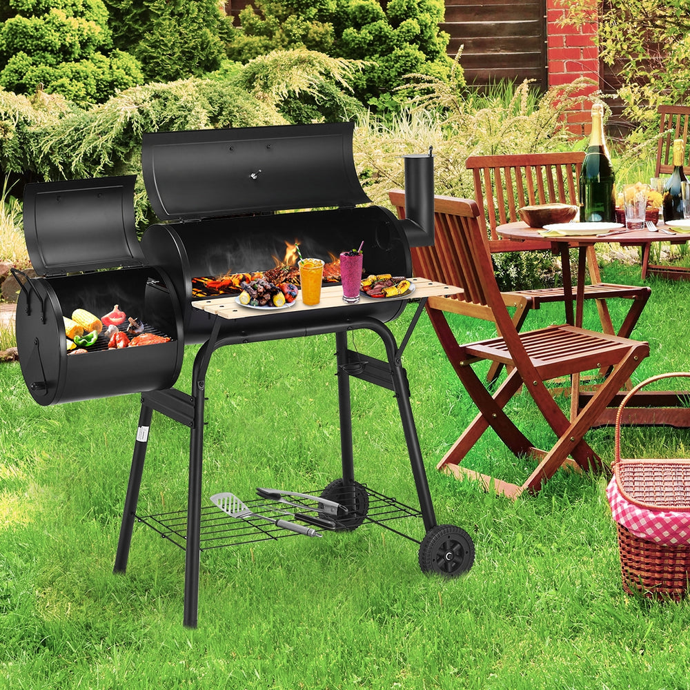 Outdoor BBQ grill with side shelf, durable steel construction, perfect for patio cooking and outdoor gatherings.