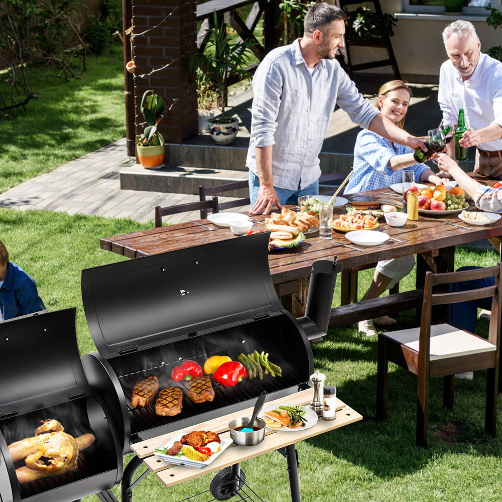 Outdoor BBQ grill with heavy-duty steel construction, side shelf for tools, perfect for patio cooking and gatherings.