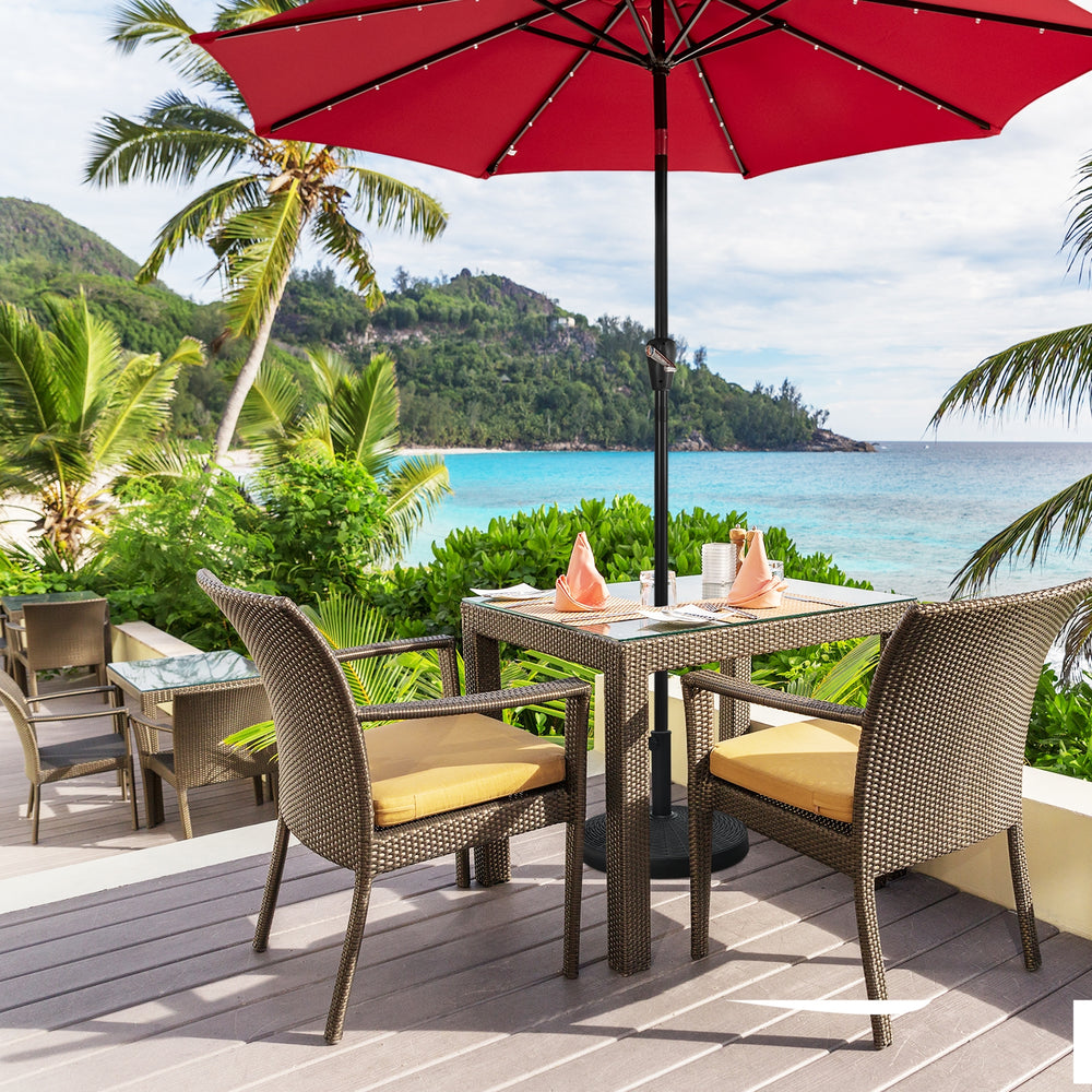 Patio resin umbrella base stand with imitation rattan style, weighing 49 lbs for stability in outdoor settings.