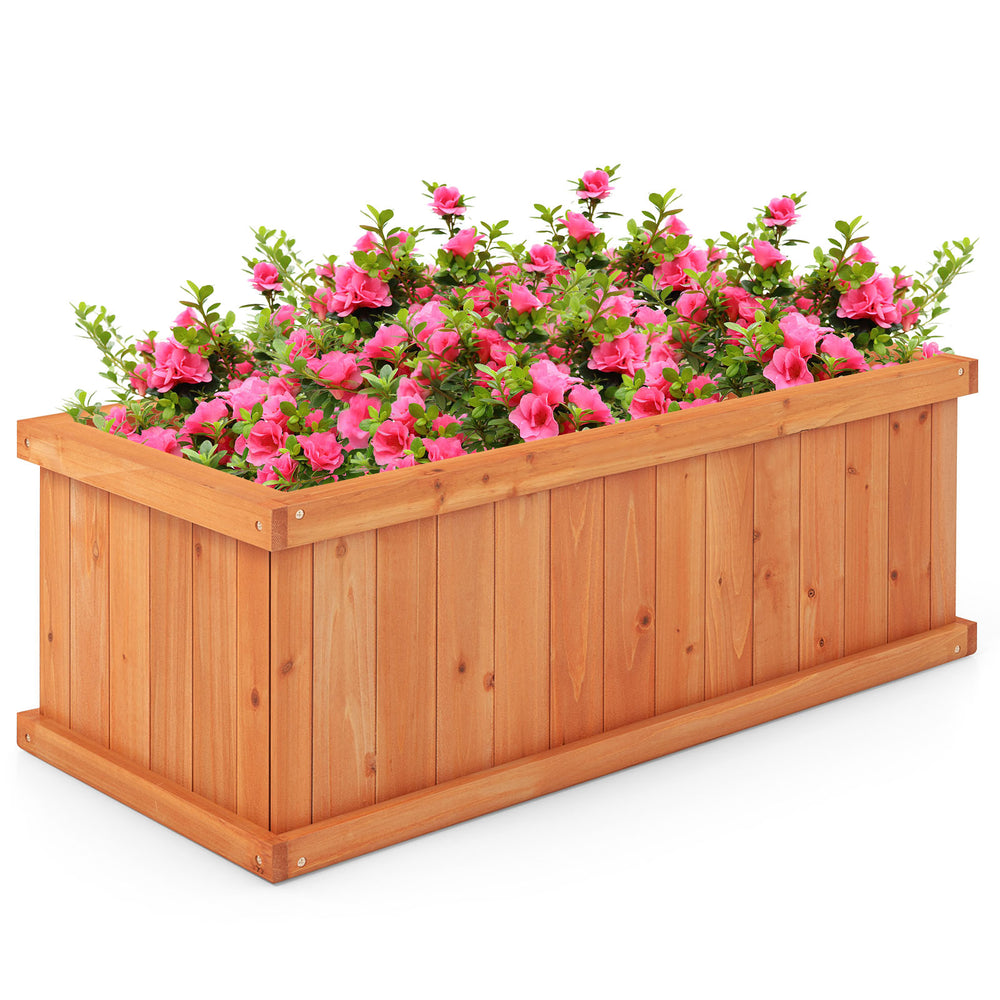 Raised wooden planter box with pink flowers, featuring 4 drainage holes and detachable bottom panels for versatile use.