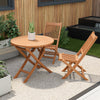 Outdoor bistro set featuring a round teak wood table and slatted folding chairs, perfect for backyard relaxation.