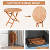 Folding outdoor bistro table made of teak wood, showcasing its space-saving design for backyard or camping use.