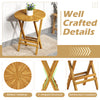Round teak wood patio folding side table with slatted tabletop and X-shaped frame, perfect for balcony or porch use.