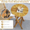 Round teak wood folding side table with slatted top and X-shaped frame, perfect for patio or balcony use.