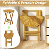 Round teak wood folding side table with slatted tabletop and X-shaped frame, perfect for patio or balcony use.