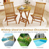 Teak wood round folding side table with slatted top, ideal for patio, garden, or poolside use.