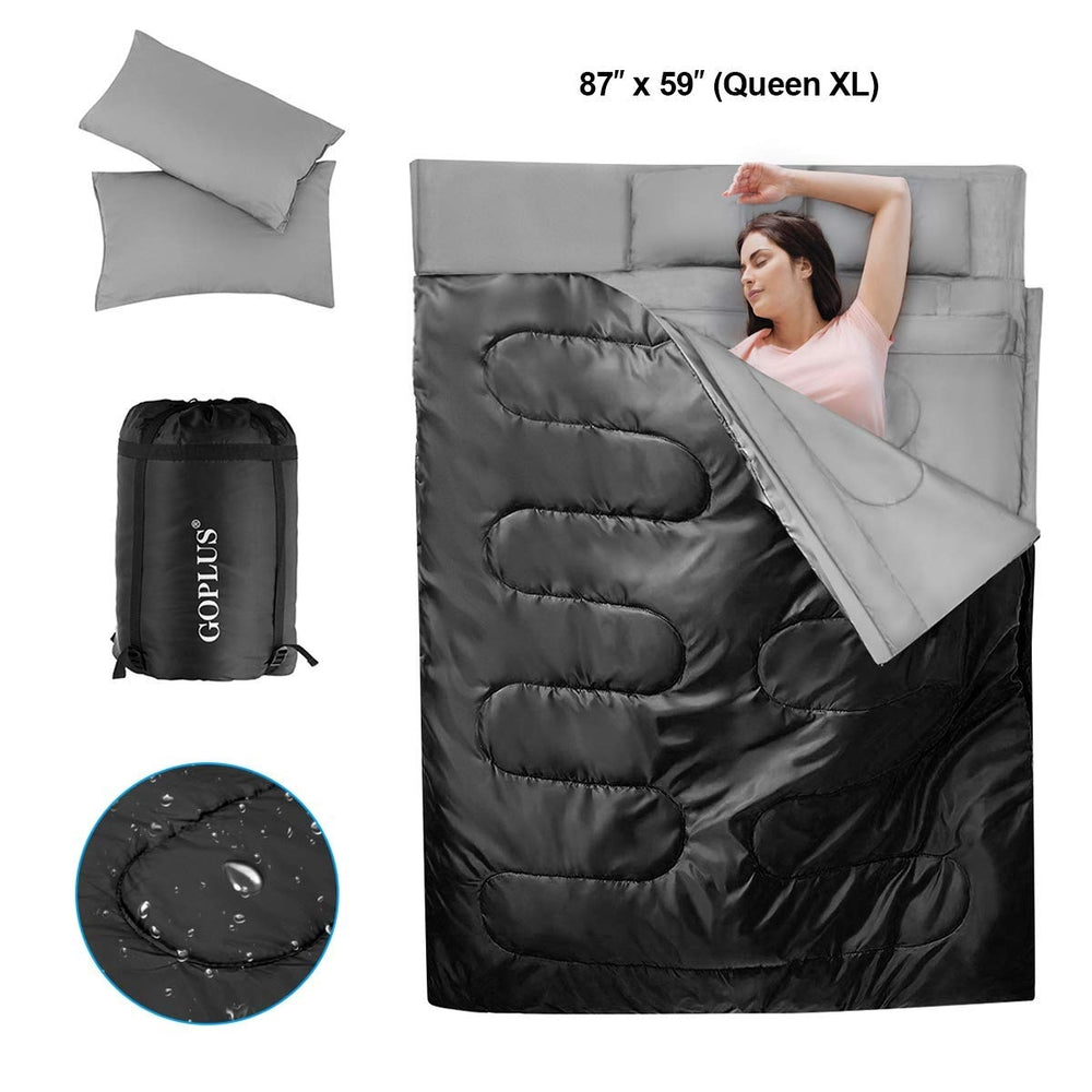 Two-person waterproof sleeping bag in black with two pillows, designed for camping and travel, featuring zippers and.