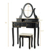 Close-up of the oval mirror with 12 LED bulbs on the black vanity table, providing warm light for detailed makeup.