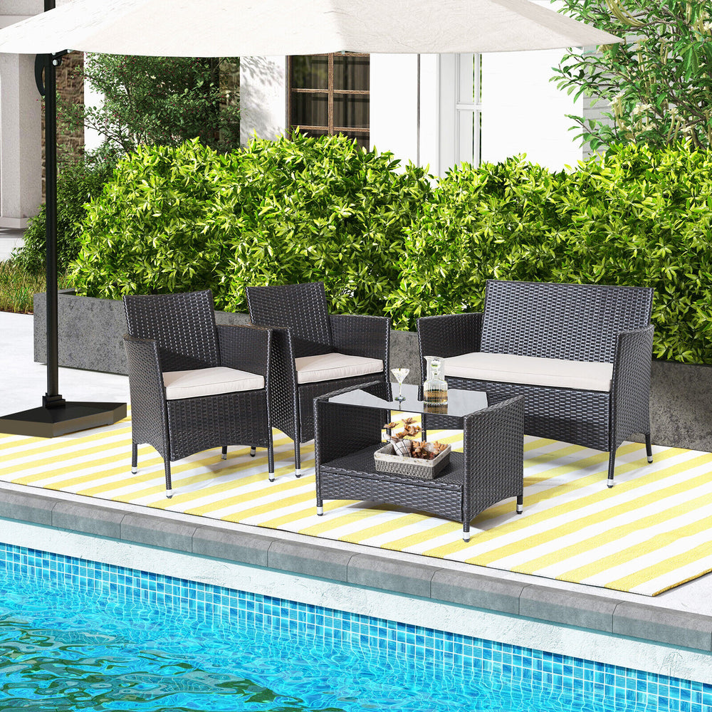 4-piece patio conversation set featuring brown PE rattan, soft cushions, and a tempered glass tabletop, ideal for.