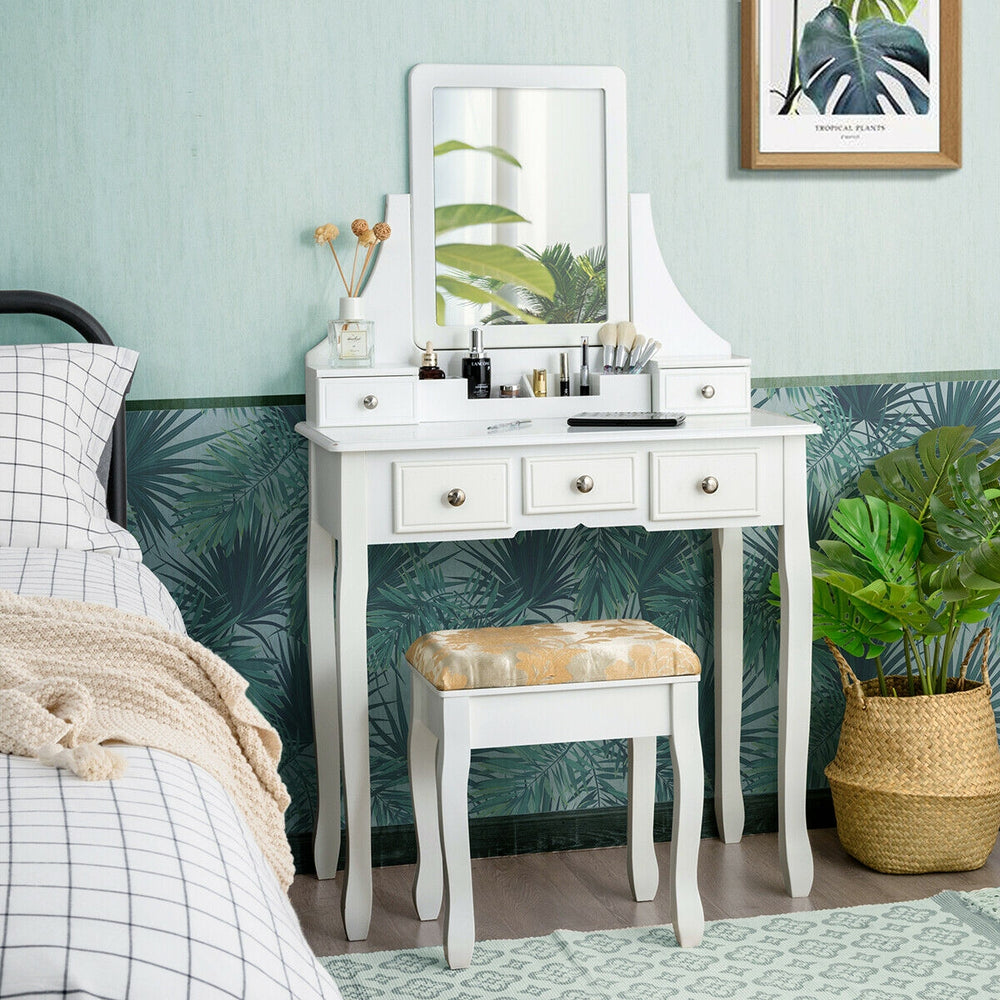 White makeup dressing vanity set with 5 drawers, removable mirror, and padded stool for a stylish and functional setup.