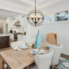 20-inch metal chandelier with pivoting interlocking rings, featuring five E12 bulb holders, ideal for dining room.