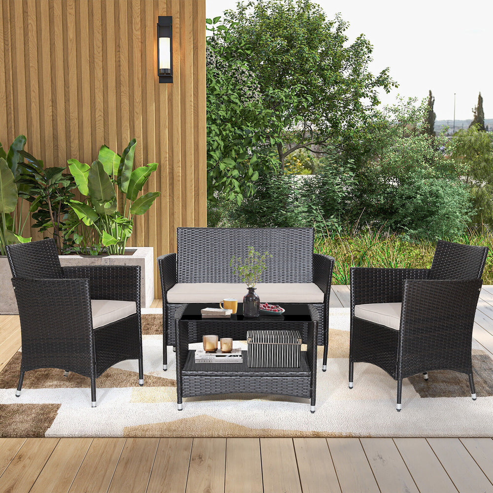 4-piece patio conversation set featuring a tempered glass tabletop, soft cushions, and durable brown PE rattan for.